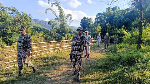 Security personnel during a search operation and area domination in the vulnerable areas of hill and valley districts of Manipur.