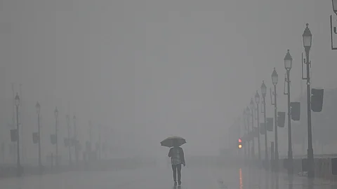 People use umbrella to protect themself from rain in New Delhi