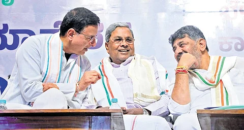 AICC general secretary Randeep Singh Surjewala shares a light moment with Chief Minister Siddaramaiah and Deputy Chief Minister DK Shivakumar during a meeting at Bharat Jodo Bhavan in Bengaluru on Monday
