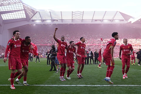 Liverpool players celebrate after clinching the Premier League title at Anfield on Sunday, April 27, 2025.