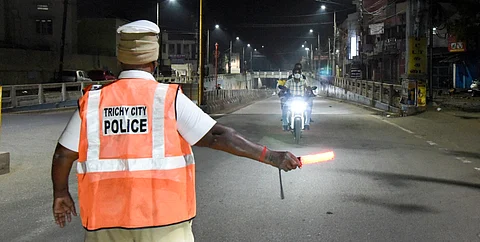 Tiruchy city police monitoring traffic at night.