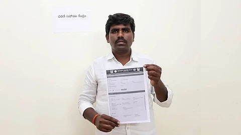 Begari Shivaiah, a farmer from Gundlamachanoor village in Hathnoora mandal, is seen displaying the pattadar passbook issued to him by the Collector at the Collectorate. He received the passbook after six years, as his land had been listed under the prohibited category in Hathnoora mandal.