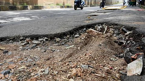 Image of a road with a pothole used for representational purposes only.