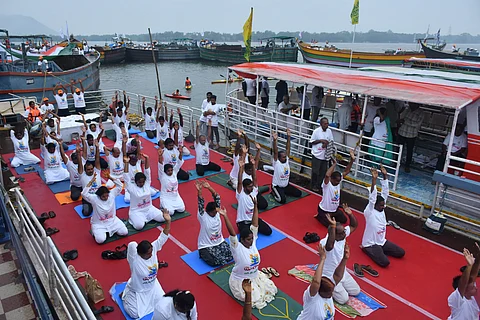 Citizens of Vijayawada take part in Water Crafts - Floating Yoga campaign under the theme of Yogandhra-2025 at Berm Park in River Krishna on Wednesday.