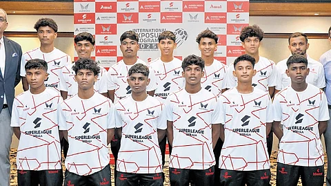 The young footballers who were selected for 12-day training in Malaysia pose with Super League Kerala CEO Mathew Joseph (extreme left) and SLK director Feroz Meeran (extreme right) in Kochi on Thursday.