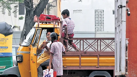 A mother hands pocket money to her daughter as she leaves for school on the first day of reopening at Mahbubia Girls School, Hyderabad