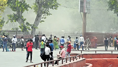 Visitors brave dust storm at Red Fort on Friday in New Delhi