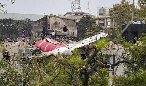 Remains of the crashed Air India plane lie on a building, in Ahmedabad, Friday, June 13, 2025.