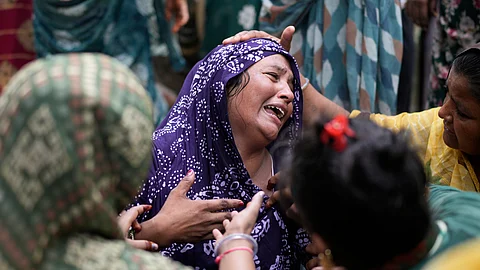 A relative of a victim of the Air India plane crash is comforted as she breaks down at a hospital in Ahmedabad, India, Friday, June 13, 2025.