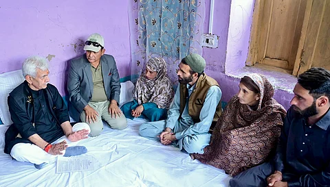 Jammu and Kashmir Lieutenant Governor Manoj Sinha meets the family members of Syed Adil Hussain Shah, a local, who died in the Pahalgam terror attack while trying to save the tourists, in Anantnag on Saturday.