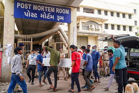 Families collect the mortal remains of victims of the Ahmedabad plane crash.