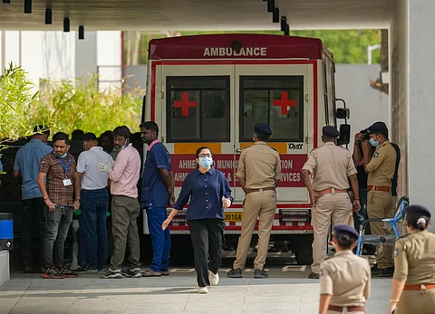 Medics and police personnel outside the mortuary of a hospital, where victims of the Air India plane crash were admitted, in Ahmedabad, Sunday, June 15, 2025. A London-bound Air India plane crashed moments after taking off from the Ahmedabad airport on Thursday, killing 241 people on board, and several others on the ground.