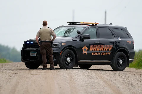 A Sibley County Sheriff's Deputy blocks the road where the suspect involved in the shooting of two state lawmakers vehicle was found Sunday, June 15, 2025, in Faxon Township, Minn.