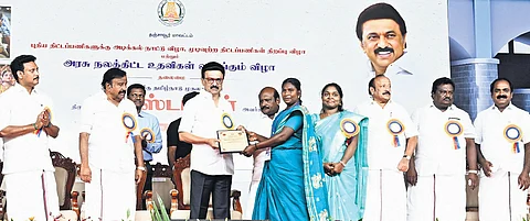Chief Minister MK Stalin distributing welfare assistance to a beneficiary at a function in Thanjavur on Monday.