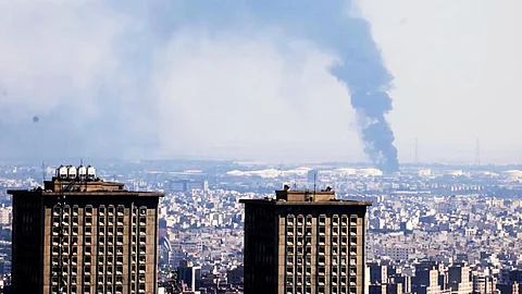 Smoke billows in the distance from an oil refinery following an Israeli strike on the Iranian capital Tehran on Tuesday.