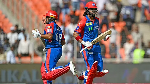 Delhi Capitals' KL Rahul (R) and Karun Nair run between the wickets during the IPL Twenty20 cricket match between Gujarat Titans and Delhi Capitals at the Narendra Modi Stadium in Ahmedabad on April 19, 2025.
