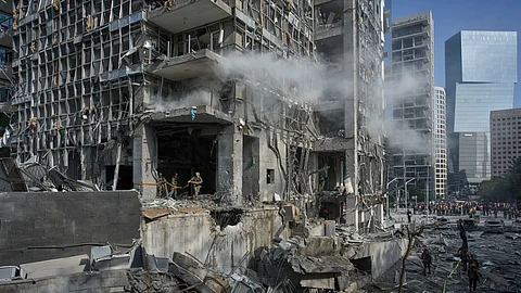 Rescue workers and military personnel inspect the site of a direct hit from an Iranian missile strike in Ramat Gan, Israel, Thursday, June 19, 2025.