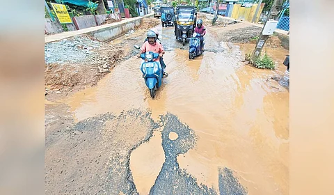 Motorists negotiate a difficult stretch on the Tirumala-Thrikkannapuram road riddled with enormous potholes