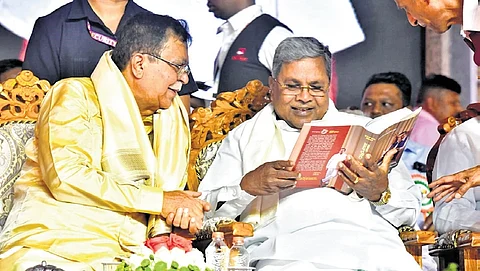 CM Siddaramaiah and Minister KN Rajanna share a light moment at a programme to mark the latter’s 75th birthday, in Tumakuru on Saturday