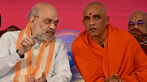 Union Home Minister Amith Shah with Adichunchanagiri mutt seer Nirmalanandanatha swami during the inauguration of BGS Medical College and Hospital in Bengaluru on Friday.