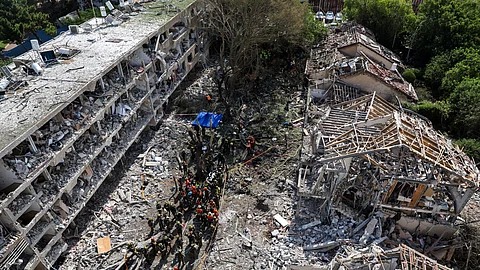 Israeli security forces and first responders gather at the site of an Iranian strike that hit a residential neighbourhood in the Ramat Aviv area in Tel Aviv on June 22, 2025