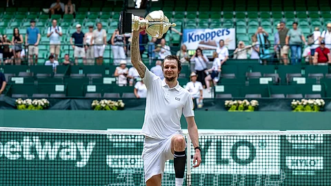 Kazakhstan's Alexander Bublik holds the trophy after defeating Russia's Daniil Medvedev in their men's single final of the Halle tennis tournament, Germany, Sunday, June 22, 2025.