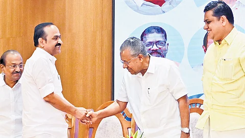 Leader of the Opposition V D Satheesan and Chief Minister Pinarayi Vijayan shaking hands during the release event of the Malayalam translation of the constituent assembly debates at Sankaranarayanan Thampi Hall on Tuesday