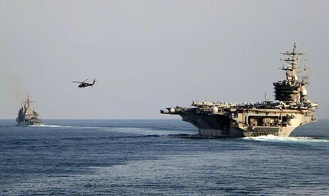 The aircraft carrier USS Dwight D. Eisenhower and other warships crosses the Strait of Hormuz into the Persian Gulf on Sunday, Nov. 26, 2023.