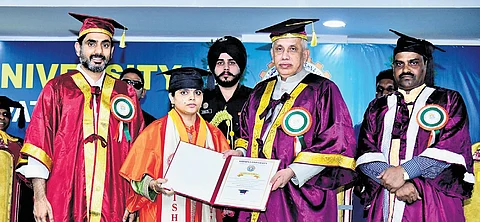 Governor S Abdul Nazeer and HRD Minister Nara Lokesh presenting degrees to graduates at the Krishna University convocation on Wednesday
