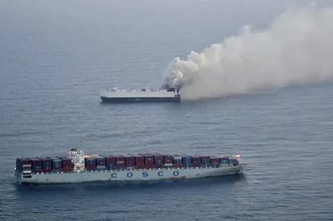 In this photo provided by the U.S. Coast Guard, smoke rises from cargo vessel Morning Midas approximately 300 miles south of Adak, Alaska, June 3, 2025.