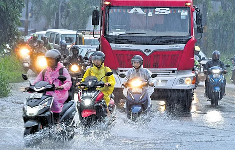 Vehicles navigate a waterlogged road in Kalamassery on Thursday