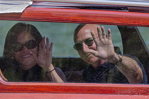 Amazon multi-billionaire founder Jeff Bezos, right, and Lauren Sanchez arrive by boat at a hotel in Venice, Italy, on Wednesday, June 25, 2025, ahead of festivities in the lagoon city reportedly linked to their wedding.