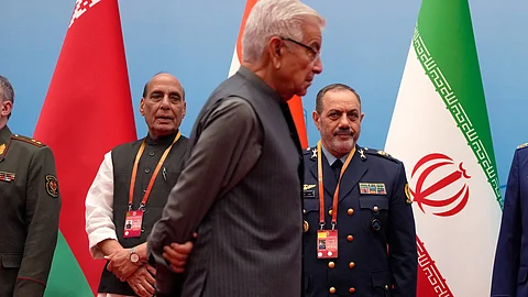 Indian Defence Minister Rajnath Singh, left, and Iran Defense Minister Aziz Nasirzadeh, right, look on as Pakistan's Defense Minister Khawaja Muhammad Asif arrives for a group photo at the Defense Ministers' Meeting of the Shanghai Cooperation Organization Members States in Qingdao in eastern China's Shandong province on Thursday, June 26, 2025
