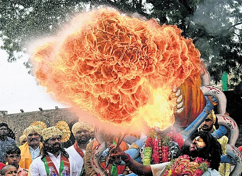 A performer breathes fire during Bonalu at Sri Jagadamba Mahankali temple, Golconda
