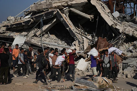 Palestinians carry humanitarian aid packages distributed by the Gaza Humanitarian Foundation operated by the U.S.-backed organization in Khan Younis, southern Gaza Strip, Thursday, June 26, 2025.