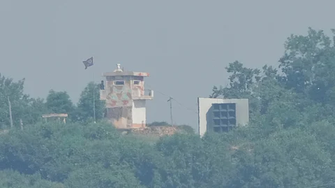 A North Korean military guard post, left, and loudspeaker are seen from Paju, South Korea, near the border with North Korea, June 12, 2025