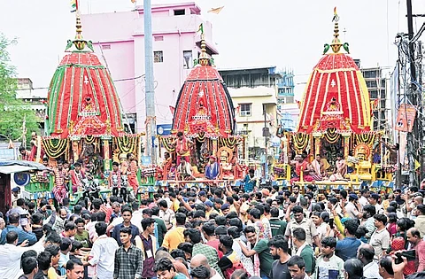 Devotees pull the chariots of the Trinity at Chandni Chowk in Cuttack.