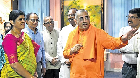 Swami Bodhamayananda, head of the Ramakrishna Math, gives a tour of the institution to Justice T Madhavi Devi during the workshop on Saturday