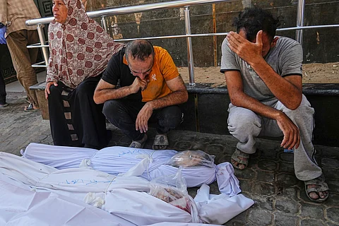 Relatives of two girls, Cila and Baraa al-Attar, who were killed along with others in an Israeli strike in the northern Gaza Strip, mourn over their bodies at Shifa Hospital in Gaza City, Saturday, June 28, 2025.