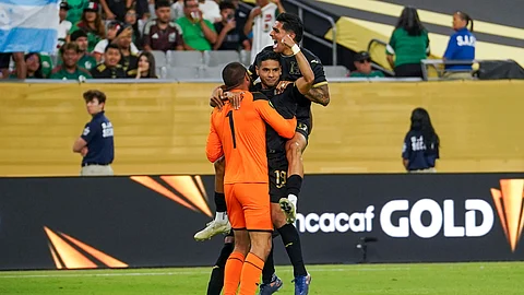 Honduras midfielder Carlos Pineda (19) celebrates scoring the game-winning penalty kick with Honduras goal keeper Edrick Menjivar (1) and Honduras forward Luis Palma (17) after a CONCACAF Gold Cup quarterfinal soccer match against Panama.