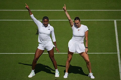 Aryna Sabalenka of Belarus, right, and Coco Gauff of United States dance during a practice session ahead of the Wimbledon Championships in London, Friday, June 27, 2025.