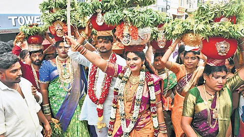 Bhagyanagar Ummadi Devalaya Committee members offer Golden Bonam to Durga after reaching Vijayawada in a colourful procession.