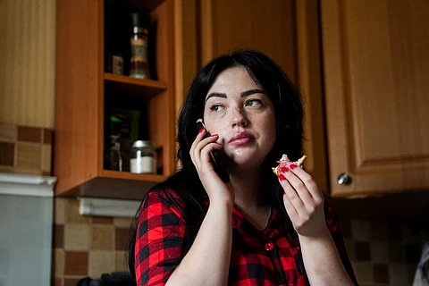 Olha Kurtmalaieva speaks via a phone while having a breakfast at her apartment in Kyiv, Ukraine, on Tuesday, June 17, 2025.