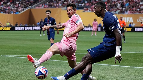 Inter Miami's Lionel Messi and Paris Saint-Germain's Willian Pacho compete for the ball during the Club World Cup round of 16 soccer match between PSG and Inter Miami in Atlanta, Sunday, June 29, 2025