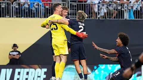 United States goalkeeper Matthew Freese celebrates with teammates after winning a penalty kick shootout of a CONCACAF Gold Cup quarterfinals soccer match against Costa Rica, Sunday, June 29, 2025, in Minneapolis.