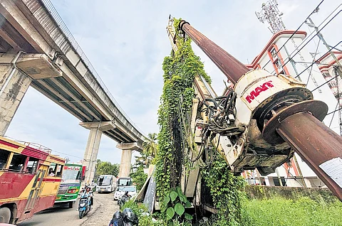 The tower crane lies abandoned on the Kaniyampuzha road at Vyttila as a stream of vehicles from the Vyttila Hub pass by