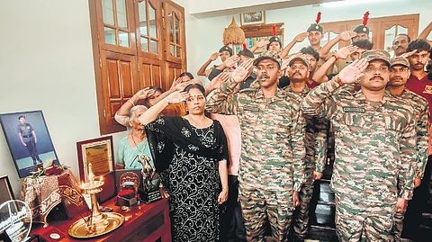 Regiment Havildar Major Rajeesh K K and other army officers with Priya K G, wife of Kargil Martyr Lance Naik Santhosh Kumar, at the latter’s residence in Vazhakulam on Tuesday