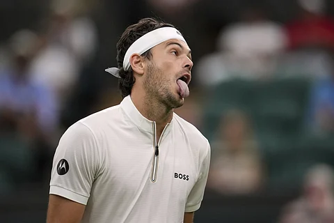 Taylor Fritz of the US reacts during his first round men's singles match against Giovanni Mpetshi Perricard of France at the Wimbledon Tennis Championships in London, Monday, June 30, 2025.