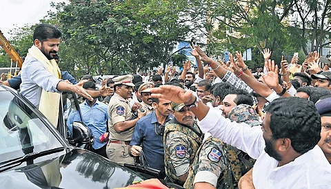 Chief Minister A Revanth Reddy greets his supporters after inaugurating the Malabar Gold and Diamonds manufacturing unit at Tukkuguda on Thursday