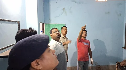 Police recreating the crime scene with the accused in the lodge room.